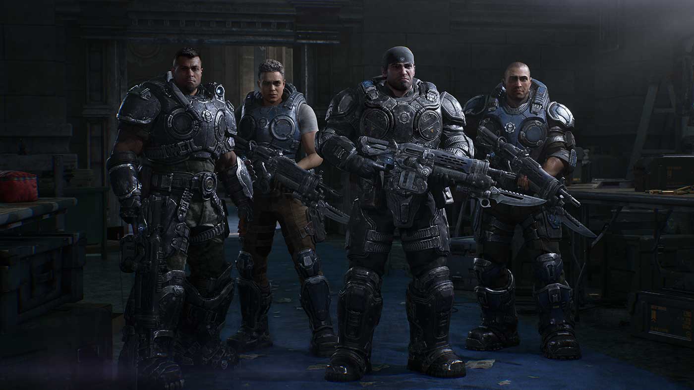 Four soldiers in futuristic armor holding weapons in a dark industrial setting.