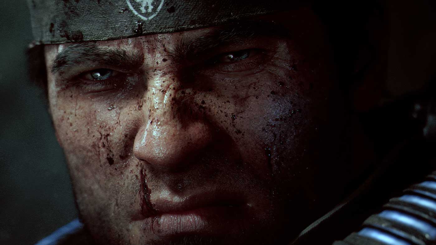 Close-up of soldier with dirt and blood on face, intense expression.