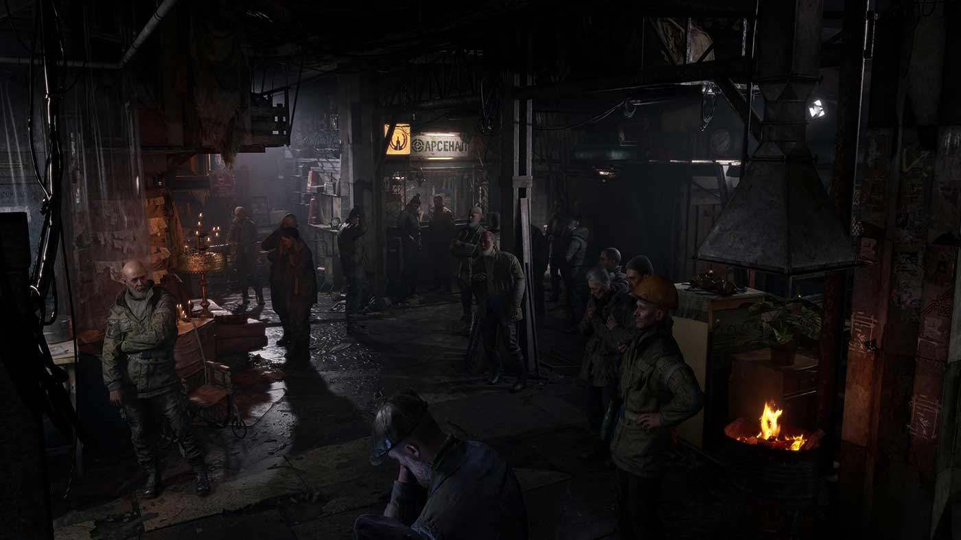 Dark gaming event scene with people and gaming setups at Press Start.