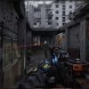 First-person shooter game scene with laser targeting in a ruined city.